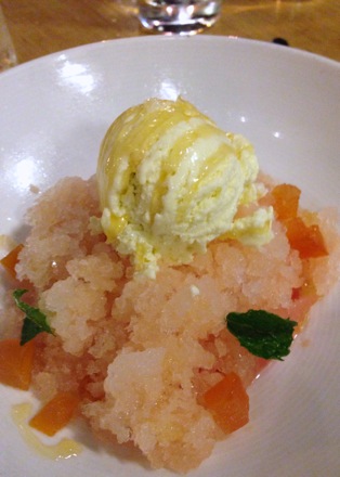 Grapefruit granita and olive oil ice cream garnished with mint and apricots
