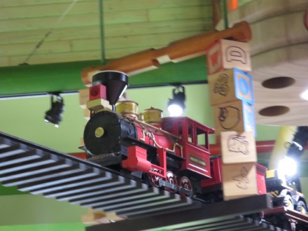 Toy train runs along the ceiling