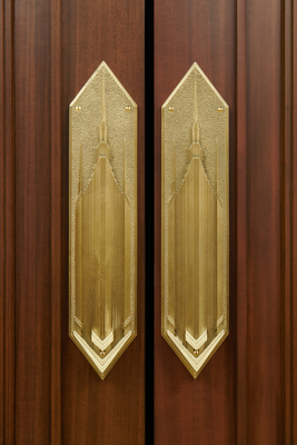 The metal plates on many of the doors depict the temple.