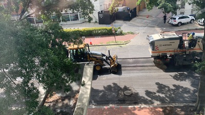 A yellow dozer chases behind.
