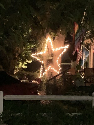A big star decoration in someone's front yard.